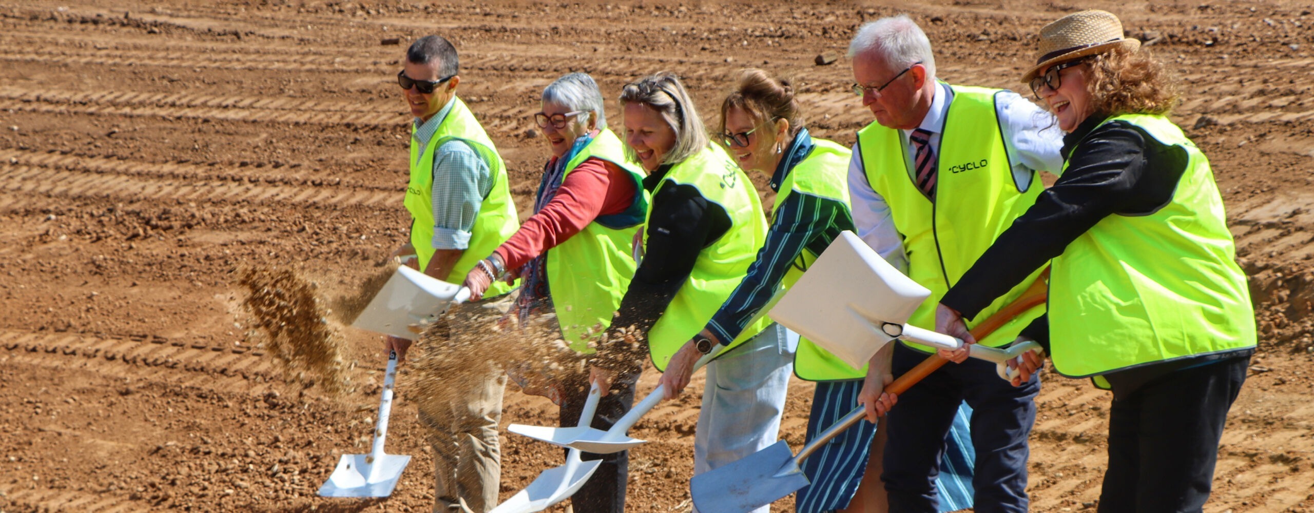 The Cowra Early Childhood Services’ team smiling and digging the first soil at the construction site for the new not-for-profit childcare centre, marking the official start of the build.