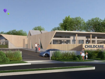 Modern childcare centre exterior featuring bright, welcoming architecture with natural materials, large windows, outdoor play areas, and landscaped surroundings - representing high-quality, purpose-built early learning environments.