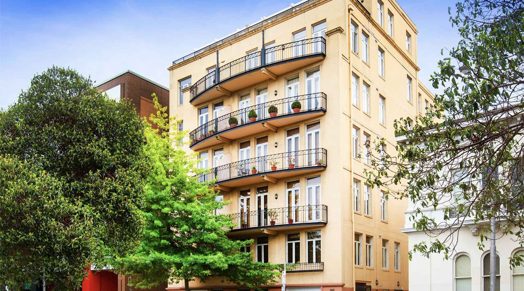 Exterior of the Albert Street residential apartments in East Melbourne featuring heritage-inspired architecture and landscaped surroundings.