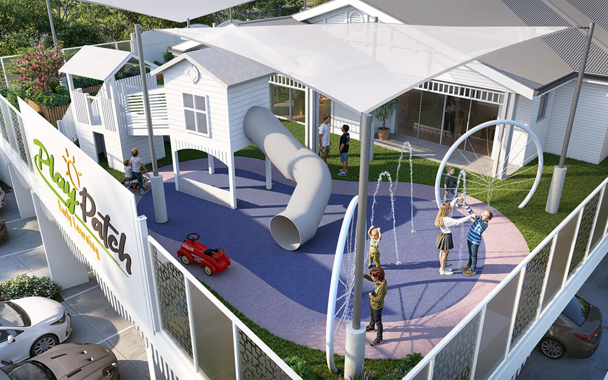 Elevated outdoor playground at Play Patch Early Learning in Annerley with a slide, water features and shade sails.