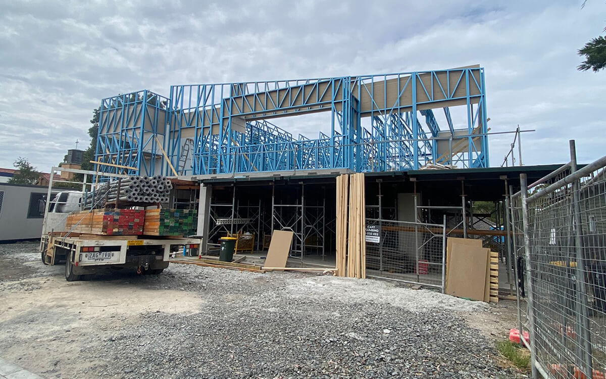 Wide view of the Coburg North Childcare Centre construction site with steel framing and structural works underway.