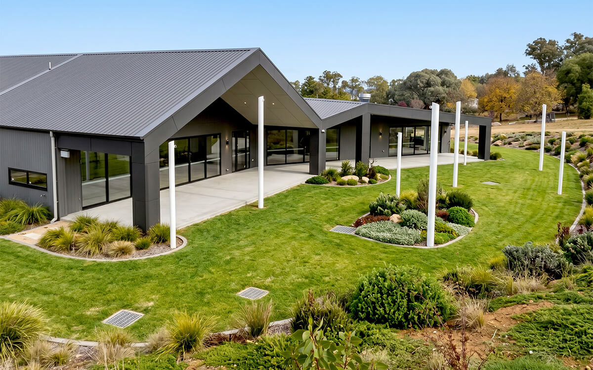 Rear view of the completed CECS Cowra Early Childhood Centre with landscaped outdoor spaces and covered walkways.