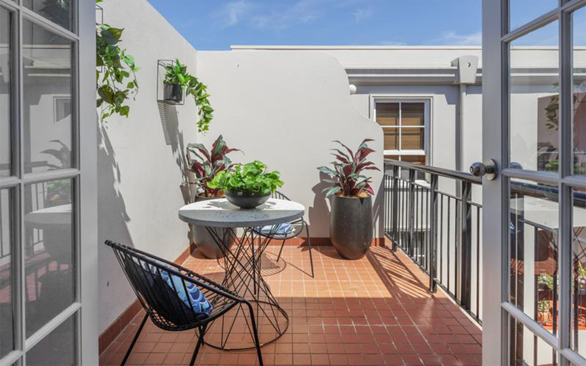 Private balcony at Henrietta Street, Hawthorne with outdoor seating and potted plants.