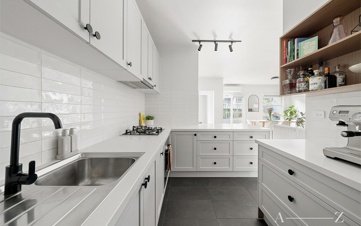 Contemporary kitchen at Henrietta Street, Hawthorne with white cabinetry and modern appliances.
