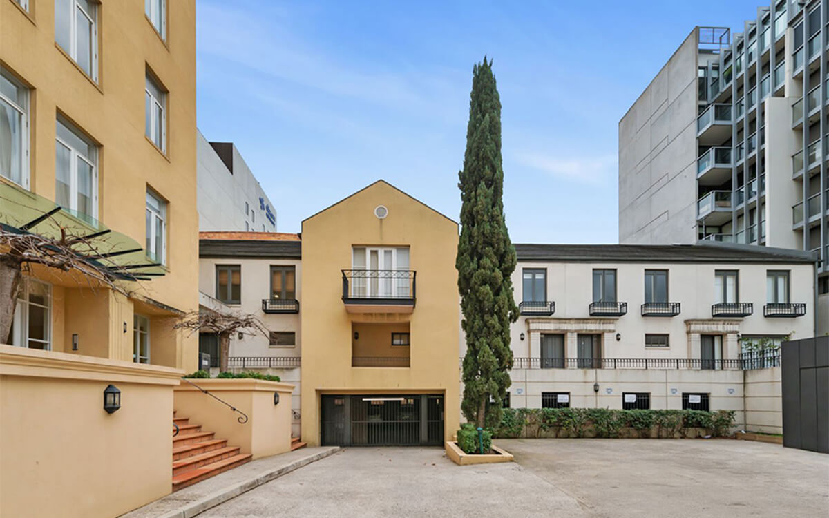 Rear townhouses and shared courtyard within the Albert Street residential development in East Melbourne.