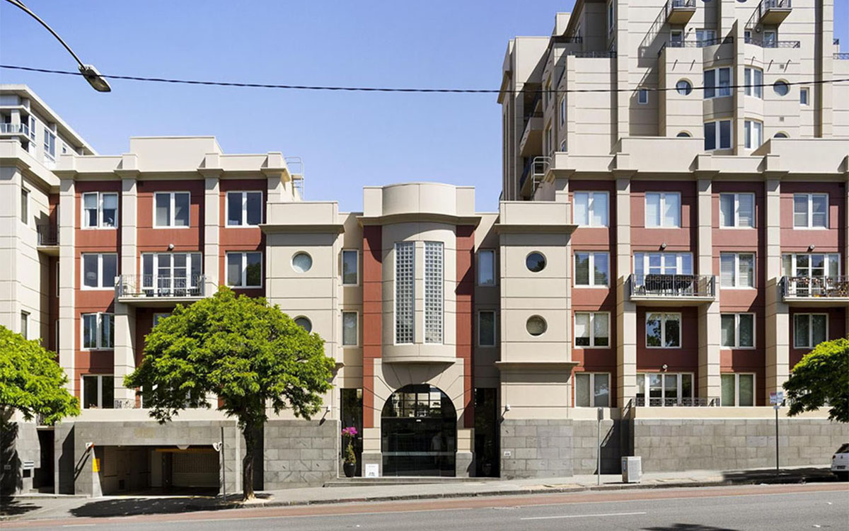 Street-facing façade of the Victoria Albert apartment building with entry and balconies.